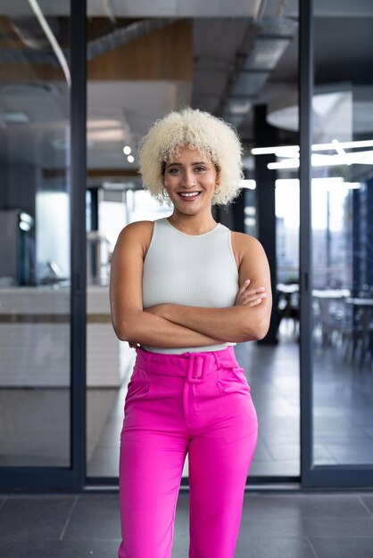 Photo in modern office young biracial woman standing smiling at camera