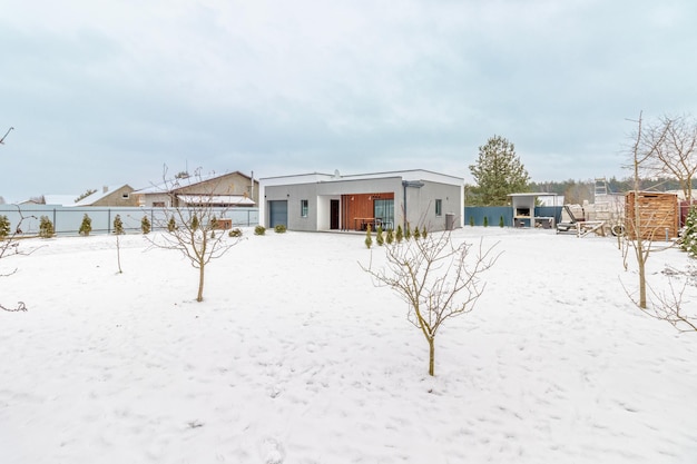 Modern onestorey house with a flat roof in winter