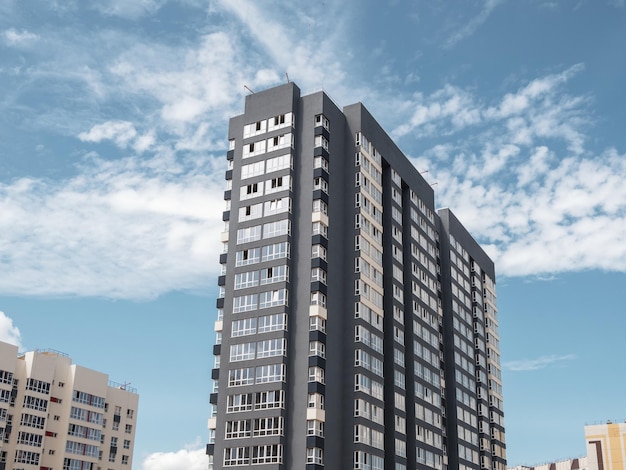 Modern panel construction new residential area Beautiful colorful new buildings Colored wall against a blue cloudy sky Copy space