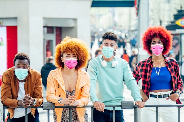 modern people posing at camera with face masks