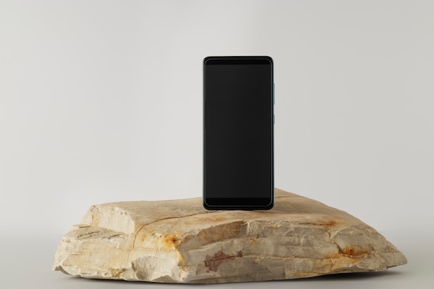 Modern phone minimal display on rock