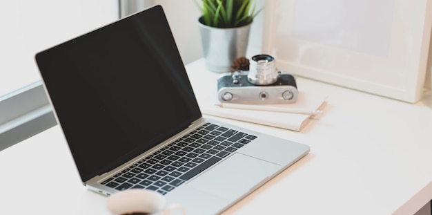 Modern photographer's workplace with open laptop computer 