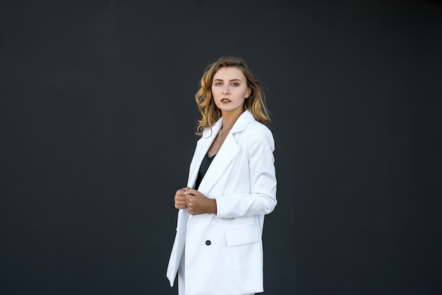 Modern pretty woman in white suit isolated