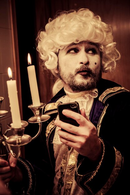 Modern prince. Young in eighteenth century image posing with candle