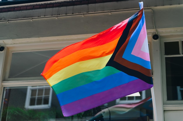 Photo modern progress lgbtq pride flag during pride month includes people of color. rainbow pride flag