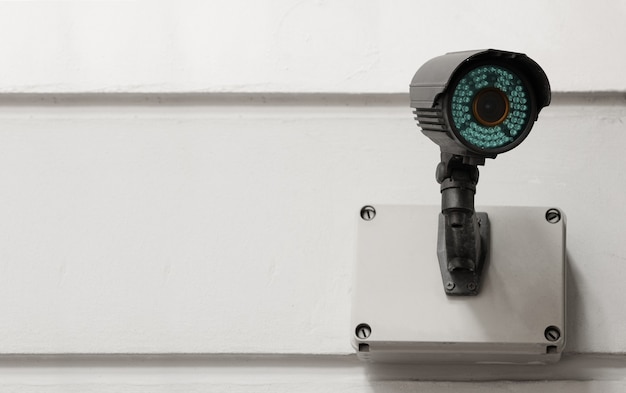 Modern public CCTV camera on cement wall