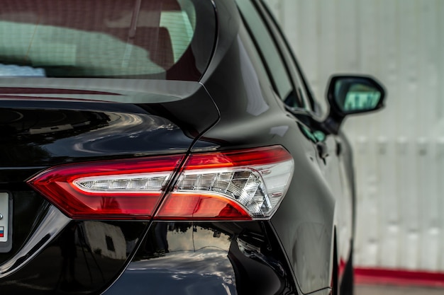 Modern rear light of a car. Brake light and arrow of large suv. Rear light of car close up view. Tail light.