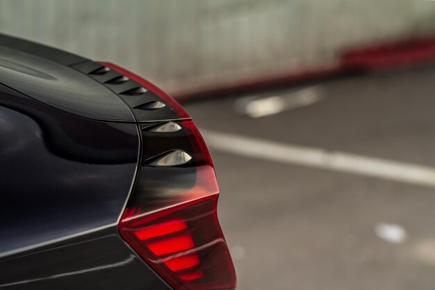 Modern rear light of a car. Brake light and arrow of large suv. Rear light of car close up view. Tail light.