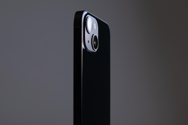 Modern rectangular black smartphone on with straight edges and two large cameras on a gray isolated