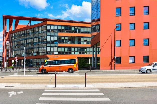 Modern red building with glass windows sky background