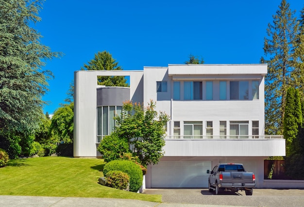 Modern residential house with car parked on driveway in front