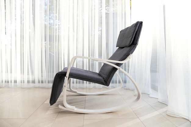 Photo a modern rocking chair stands in a spacious room comfortable seating chair