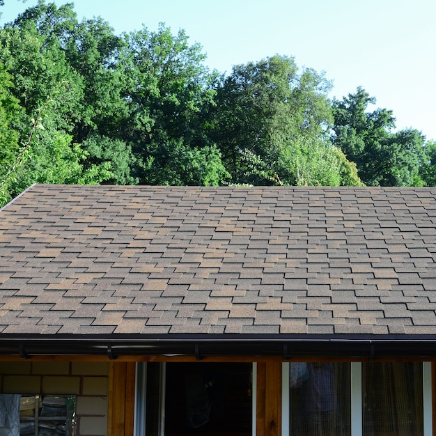 Modern roofing and decoration of chimneys. Flexible bitumen or slate shingles