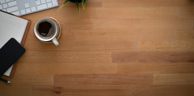 Modern rustic workplace with office supplies and cup of coffee 