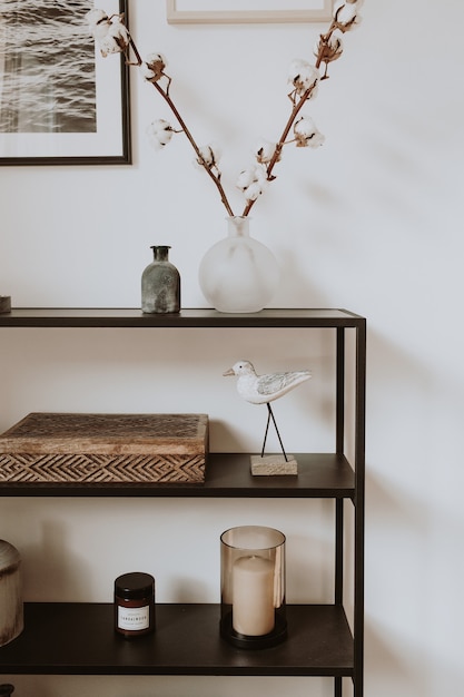 Photo modern scandinavian nordic living room with beautiful details such as black shelves, vases, frames, wooden caskets, cotton.