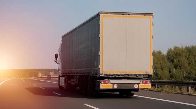 Modern semitrailer trucks on the highway driving in the right lane Commercial vehicle for shipping