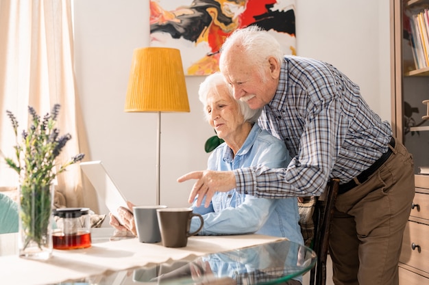 Modern Senior Couple Using Laptop