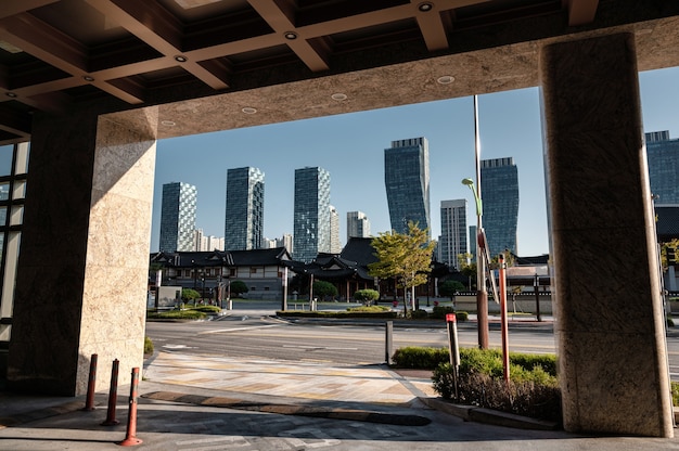 Modern skyscraper in Songdo Central Park with Ancient traditional hotel at Incheon, South Korea