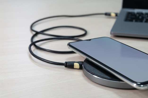 Modern smartphone are charging from wireless charger