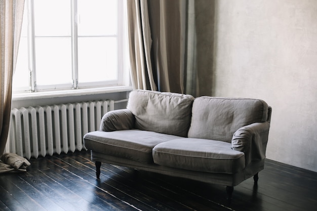 modern sofa by the window in a minimal interior