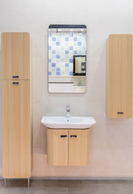 Modern spacious bathroom with bright tiles with toilet and sink. Side view