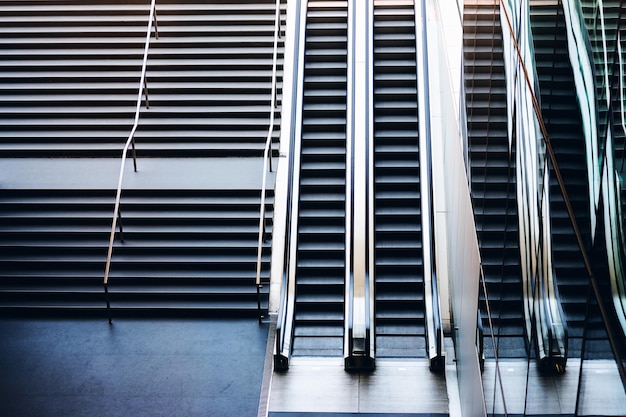 Modern stairway electric escalator of subway facility building empty stairs