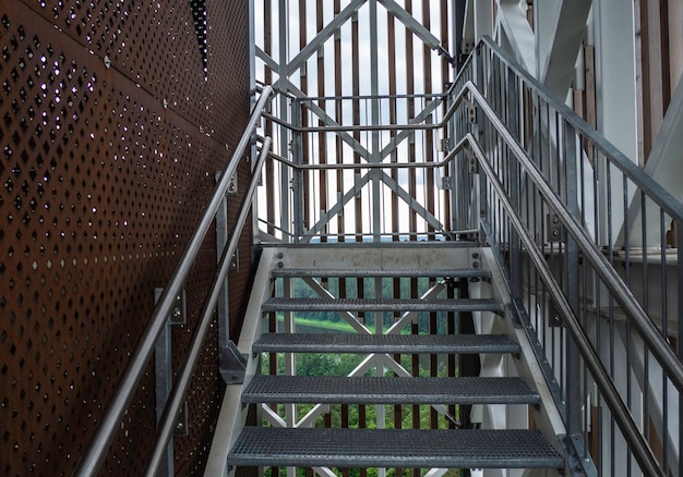 Modern steel construction with stainless steel railing and fall\
protection.