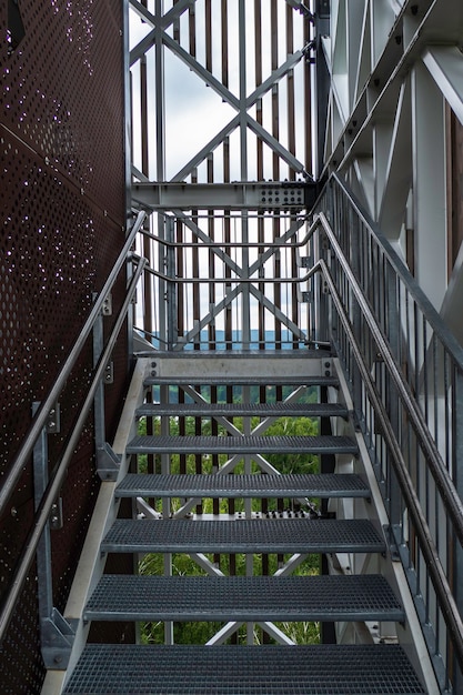 Modern steel construction with stainless steel railing and fall\
protection