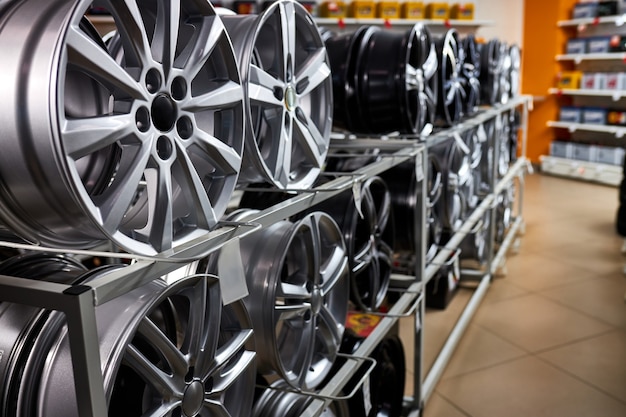 Modern store with alloy wheels and tires, indoors in shop. a lot of discs for automobile, big assortment