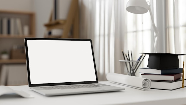 Modern student desk workspace with portable laptop and academic cap on tabletop