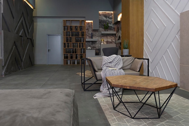 Modern studio interior with decorative stone walls in grey stone wood tiles and led lighting in the design of the room