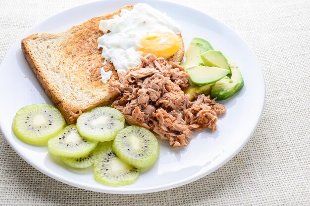 Modern style clean food bread egg tuna salad kiwi and avocado