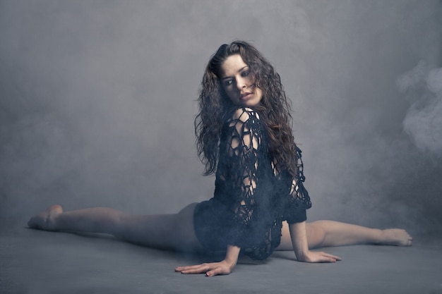 Modern style dancer posing on grey background