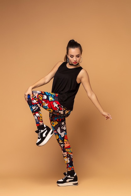 Modern style dancer posing on studio background