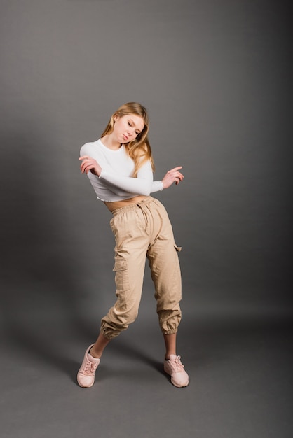 Modern style dancer posing on a studio background