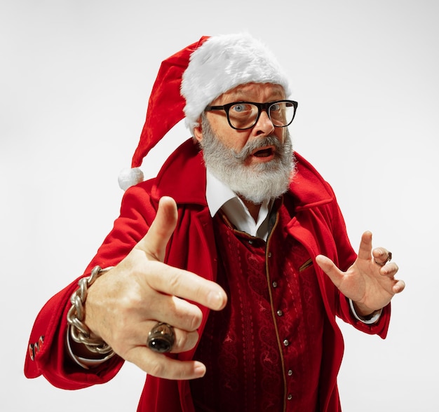 Modern stylish Santa Claus in red fashionable suit and cowboy's hat