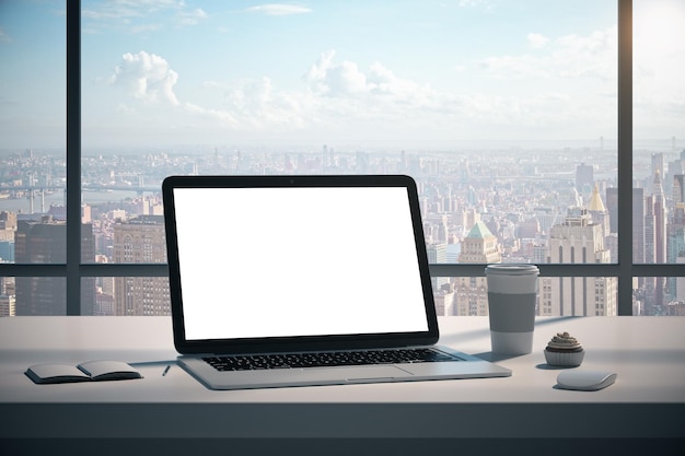 Modern table with empty white laptop