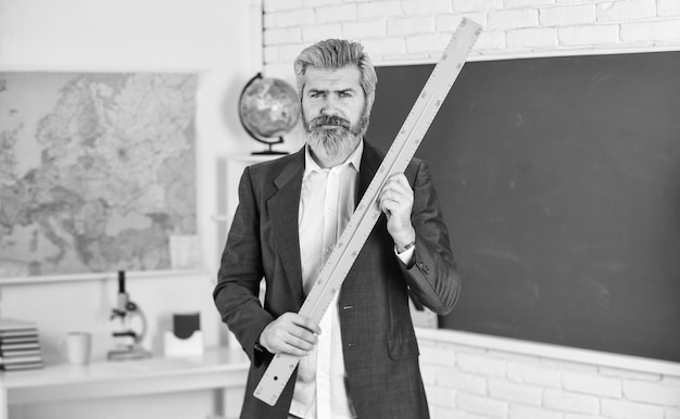 Modern teaching method each school defines final examination\
sessions modern teacher lesson study and education modern school\
knowledge day handsome bearded man in classroom chalkboard