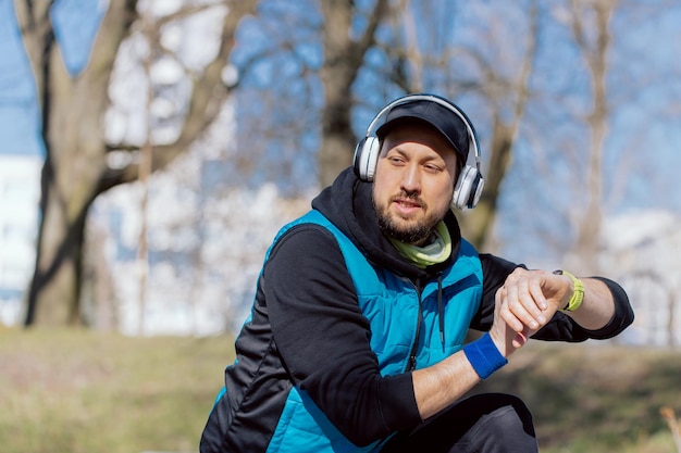 Modern technology and active lifestyle a smiling athlete exercises with a fitness bracelet