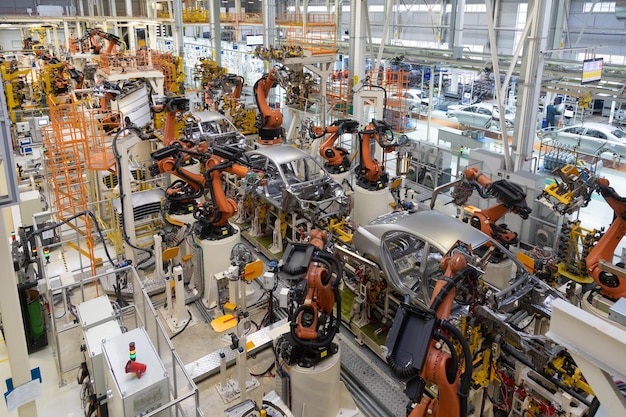 Modern technology of assembly of cars the plant of the automotive industry shop for the production and assembly of machines top view the process of welding parts of the car