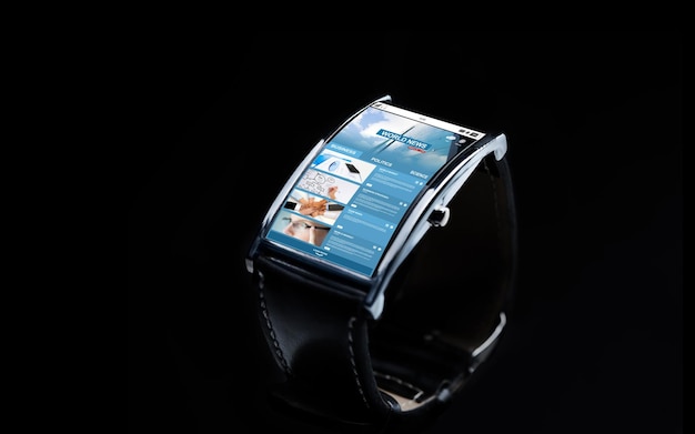 modern technology, mass media, object and media concept - close up of black smart watch with business news on screen