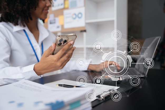 modern technology and networking concept woman using laptop tablet and smartphone with virtual screen api icon software development tool api application programming interface