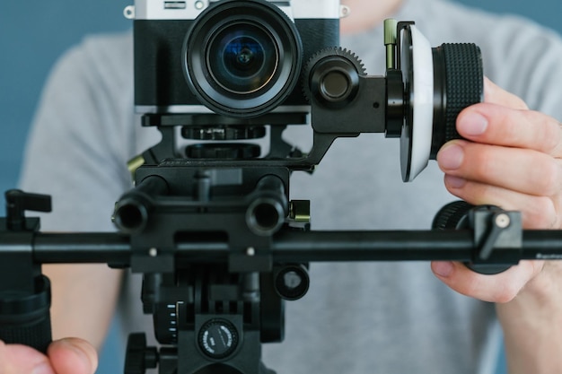 Modern technology for video shooting man using camera holder for easy and comfortable footage creation equipment and tools for blogging concept