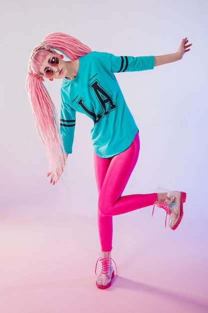 Photo modern teenage girl with pink dreadlocks on white background