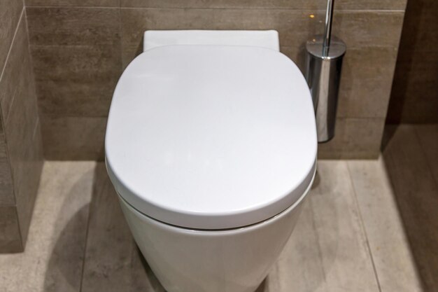 Modern toilet interior design hanging toilet bowl and brush tiled walls and floor