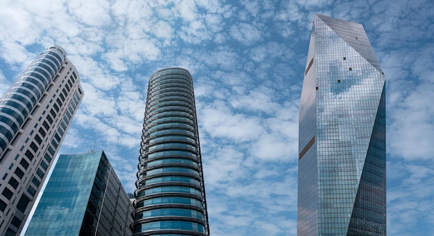 Modern tower buildings or skyscrapers in financial district\
with cloud on sunny day