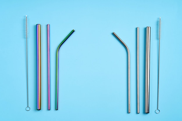 The modern trend towards caring for the environment. Kit of reusable metal beverage straws of various shape and diameters with cleaning tool.