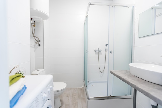 Modern twin bathroom with sinks, toilet and shower.