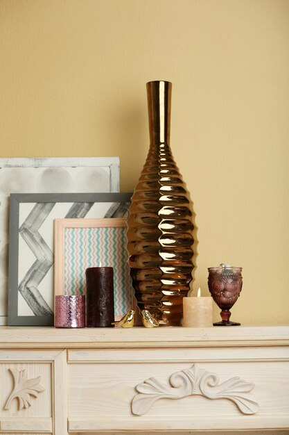 Photo modern vase with decor on fireplace in room