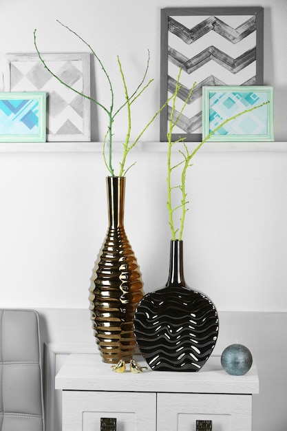 Photo modern vases on commode in room